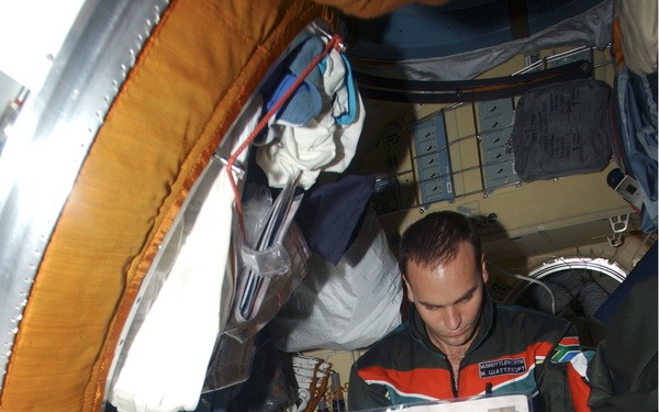 Shuttleworth reads a newspaper in the Pirs during Expedition Four