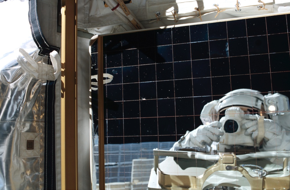 Bursch's reflection in an EETCS radiator during Expedition Four EVA 3