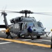 Signaling an MH-60S Sea Hawk helicopter