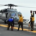 Signaling an MH-60S Sea Hawk helicopter