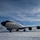 108th Wing removes snow from winter storm Nemo A U.S. Air Force aircraft, identified as serial number 3544 assigned to the 108th Wing, is parked on a snow-covered tarmac under a partly cloudy blue sky. The aircraft appears to be a KC-135 Stratotanker, a military aerial refueling tanker, in standard gray livery. The winter conditions are evident from the snow blanketing the ground around the aircraft.