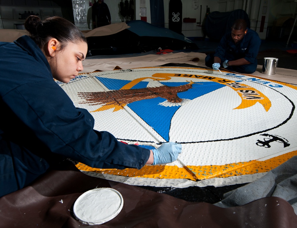 USS Carl Vinson sailors paint ship's crest