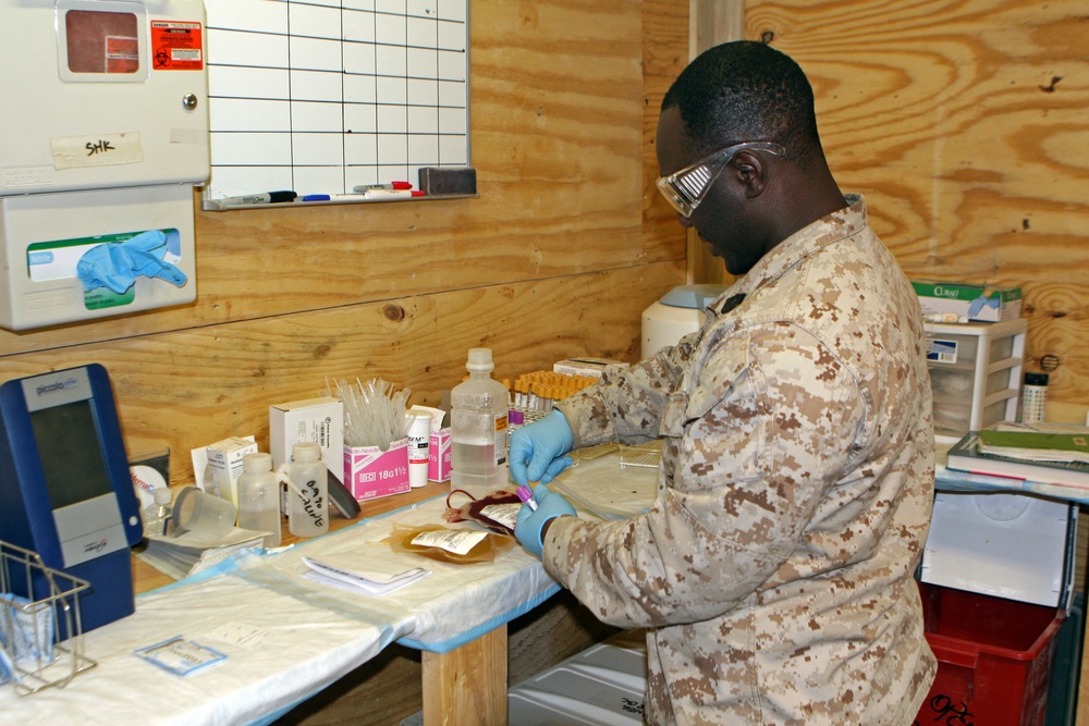 Corpsmen work to keep blood flowing