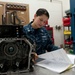 Sailor reads how to reassemble a fire pump