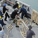 USS Frank Cable sailors heave mooring lines