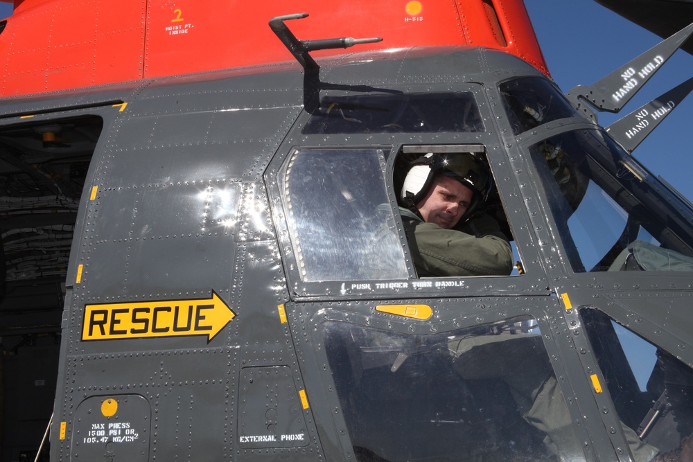 Search and rescue service members rappel into forest, save lives