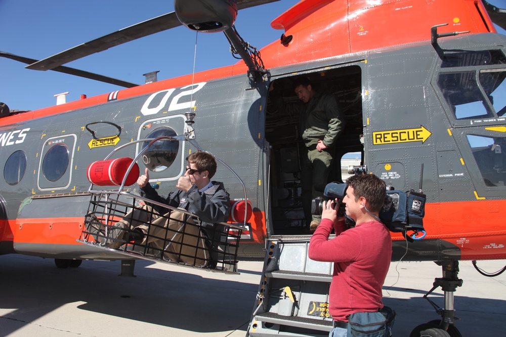 Search and rescue service members rappel into forest, save lives