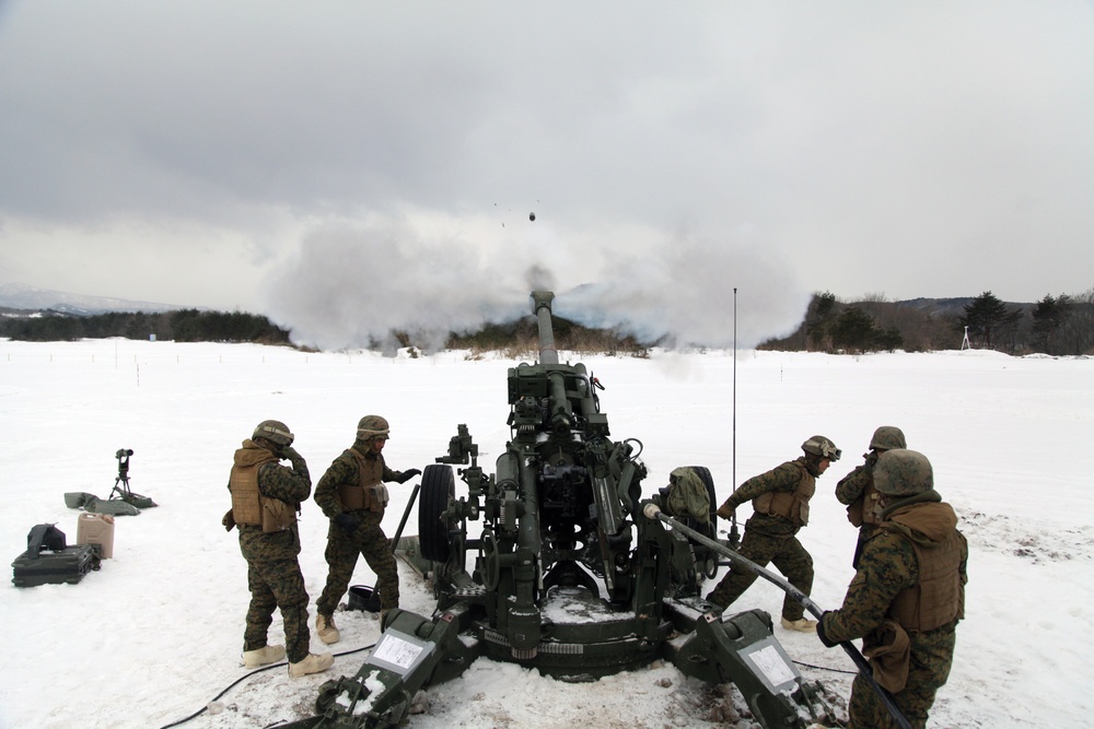 Marines fire howitzers in deep snow, frigid conditions