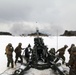 Marines fire howitzers in deep snow, frigid conditions