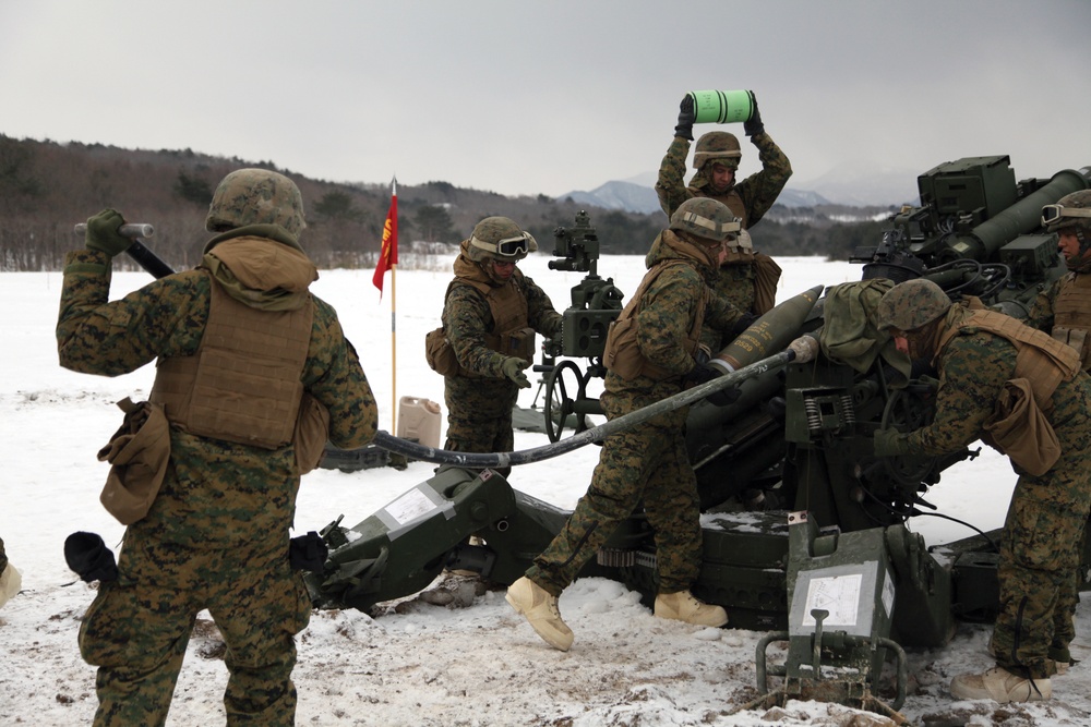 Marines fire howitzers in deep snow, frigid conditions