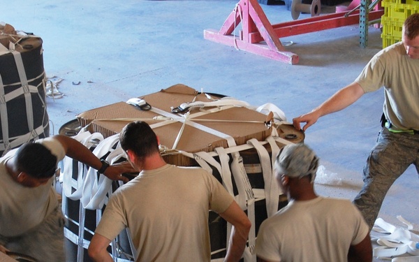 Air Force volunteers and Army riggers work hand in hand