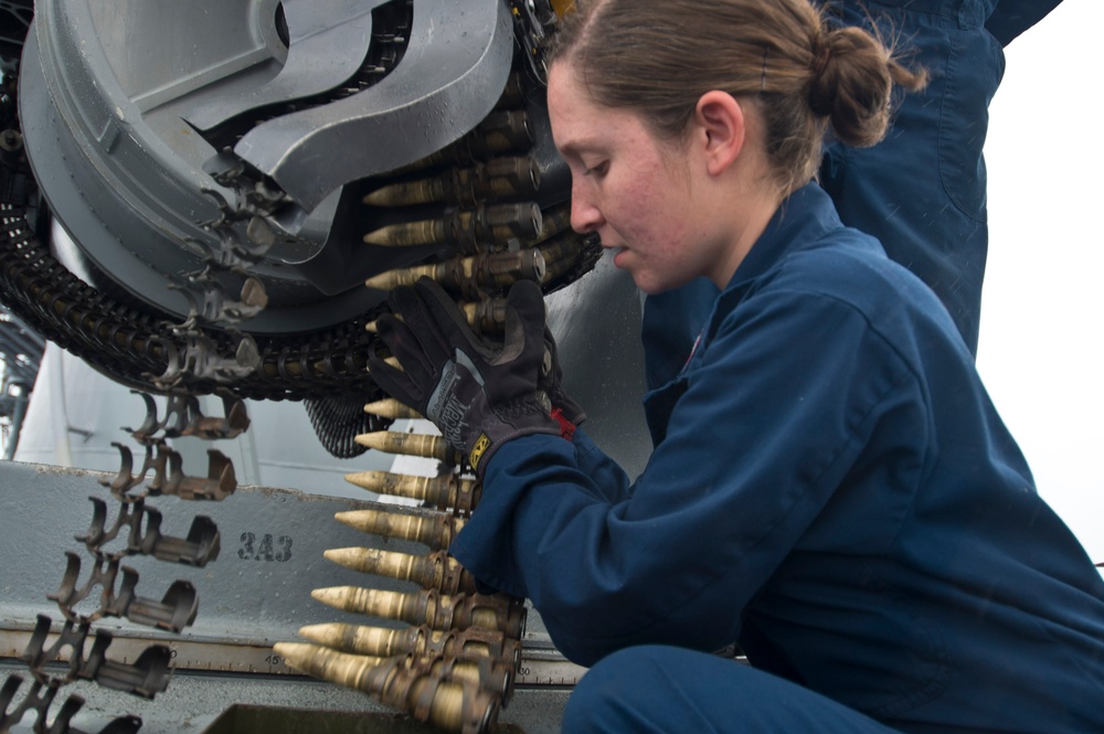 USS Hue City sailors load ammunition