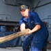 USS Carl Vinson sailors heave mooring lines