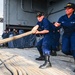 USS Carl Vinson sailors heave mooring lines