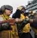 Sailors man fire hoses during drill