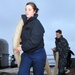 Sailors heave in mooring lines