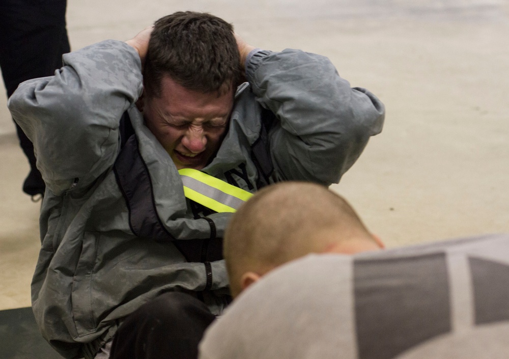 Pfc. Ballard completes the sit-up part of the Best Warrior Competiton's APFT