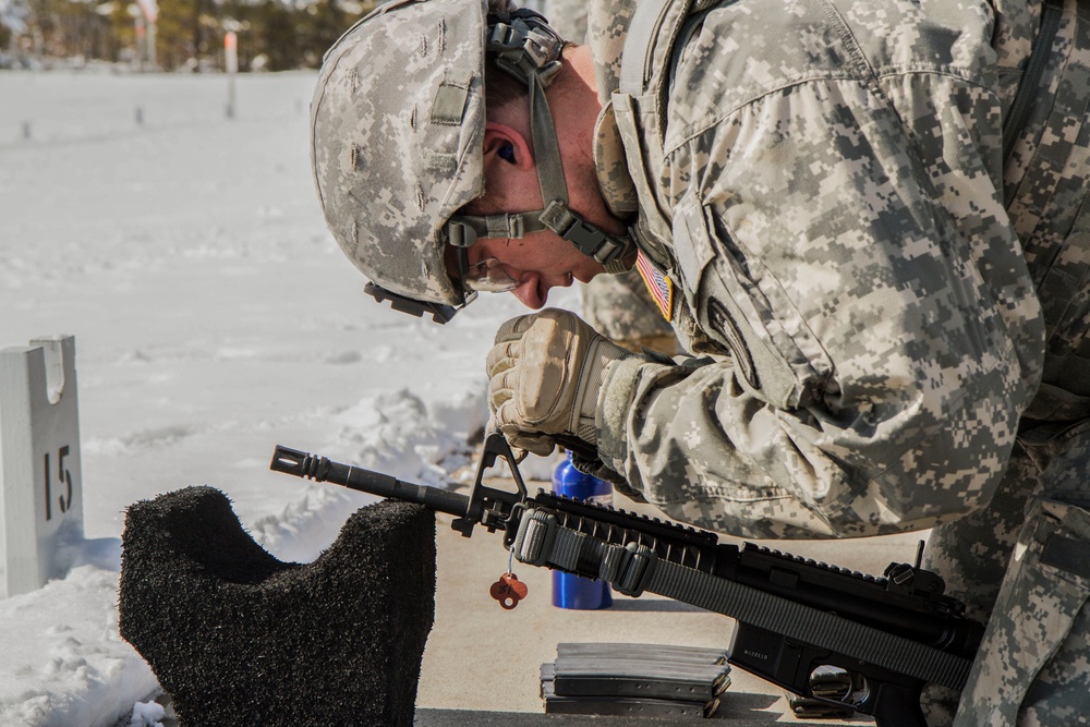 Spc. Fromm adjusts weapon for weapons qualification in the Best Warrior Competition
