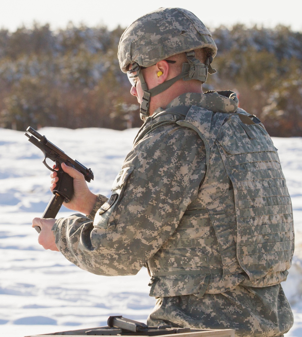Dershem reloads during weapons qualification for Best Warrior Competition