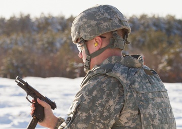 Dershem reloads during weapons qualification for Best Warrior Competition