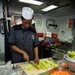 USS Mobile Bay sailor prepares meal