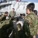 Capt. Sean Roberts, a FA-18/D Hornet pilot with Marine All Weather Fighter Attack Squadron 224, points out different parts of a FA-18/D to members of the Japan Ground Self Defense Force during a recent visit to Marine