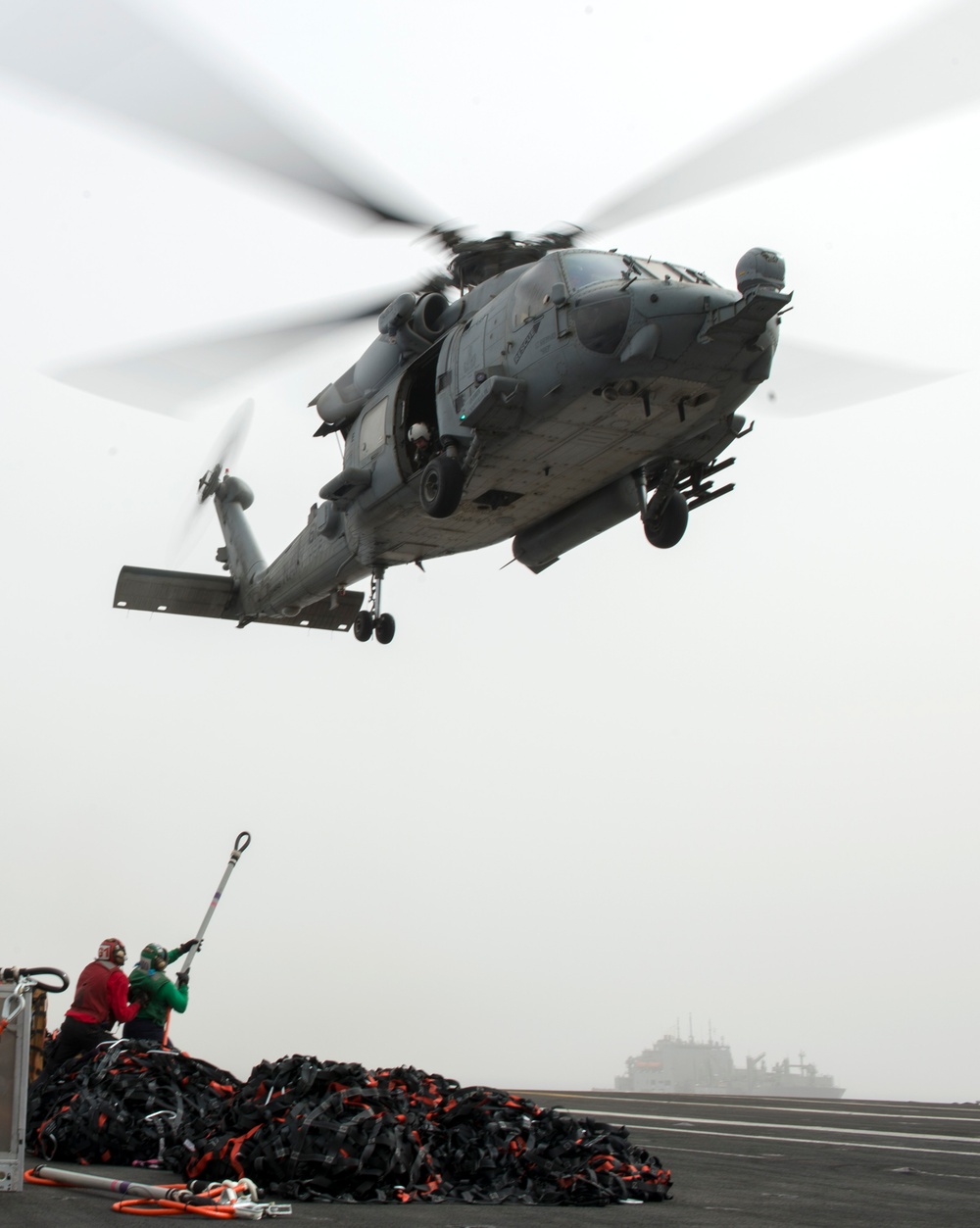 Sailors prepare to hook cargo