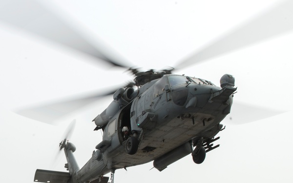Sailors prepare to hook cargo