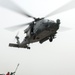 Sailors prepare to hook cargo