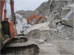 Afghan construction crew demolishes boulders on Highway 7