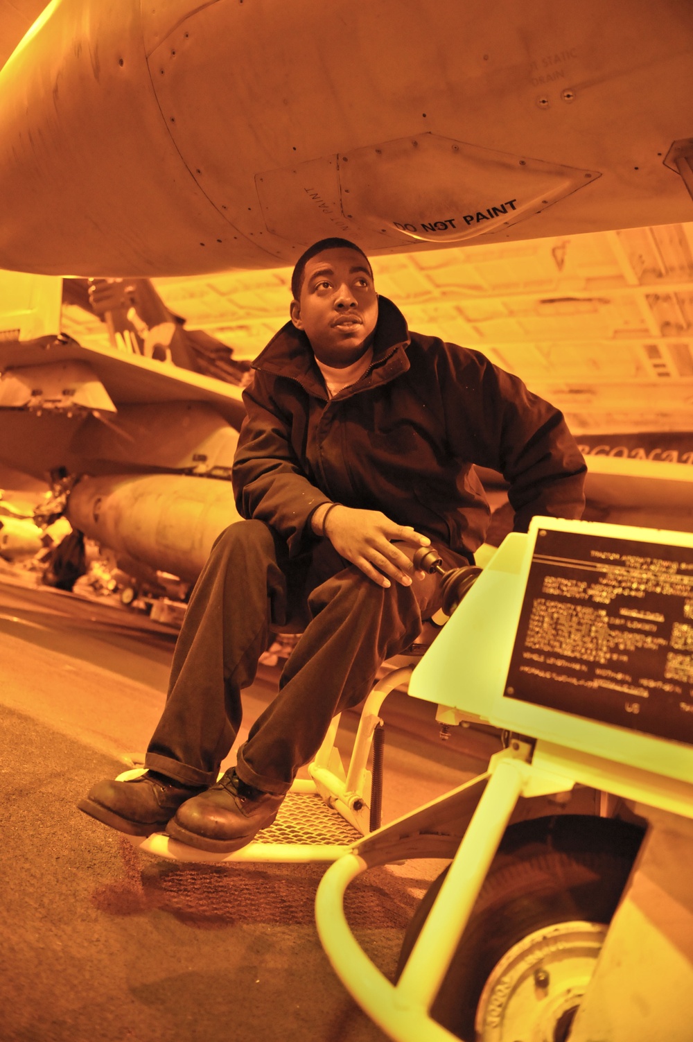 USS Nimitz sailors at work in hangar bay