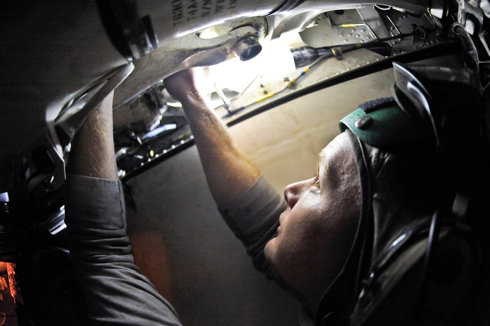 USS Nimitz sailors at work in hangar bay