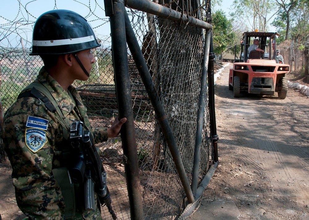 Salvadoran soldier holds gate