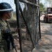 Salvadoran soldier holds gate