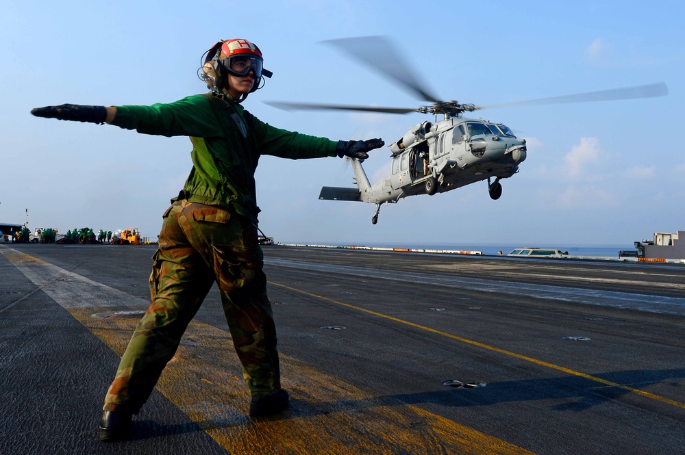 Directing an MH-60S Sea Hawk helicopter