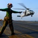 Directing an MH-60S Sea Hawk helicopter