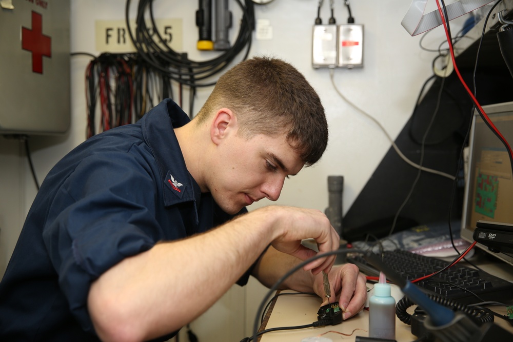 USS Kearsarge sailor repairs radio