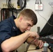 USS Kearsarge sailor repairs radio