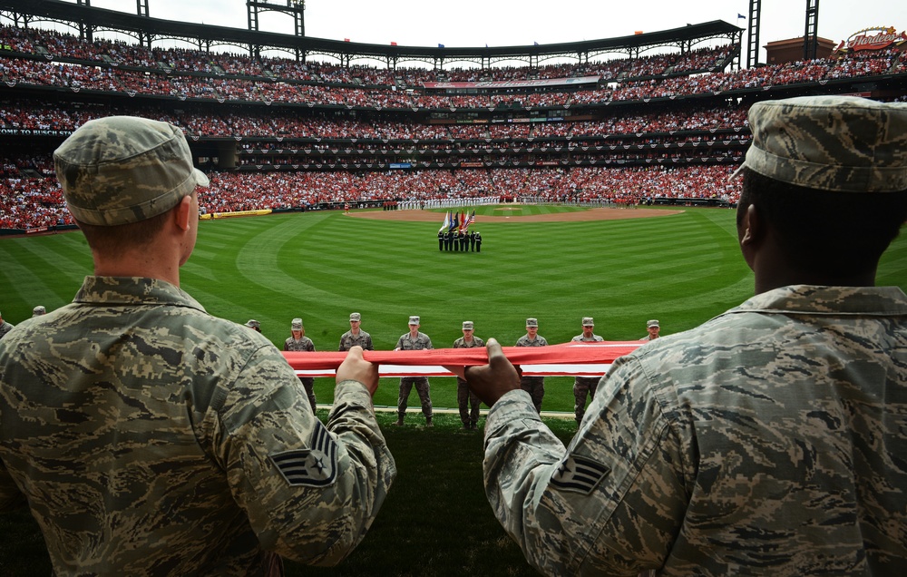 Airmen present giant US flag at Cardinals home opener