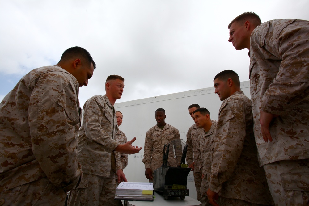 Three stripes up, crossed rifles in center: sergeants keep Corps tough