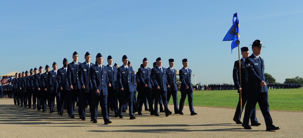 US Air Force BMT conduct pass and review during graduation parade