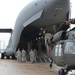 Army, Air National Guard members load HC-60 Black Hawk on board a C-17