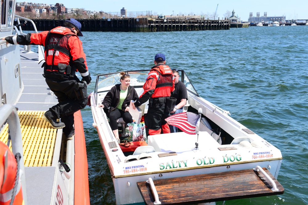 A Station Boston boat crew conducts a boarding in the Boston Harbor