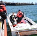 A Station Boston boat crew conducts a boarding in the Boston Harbor