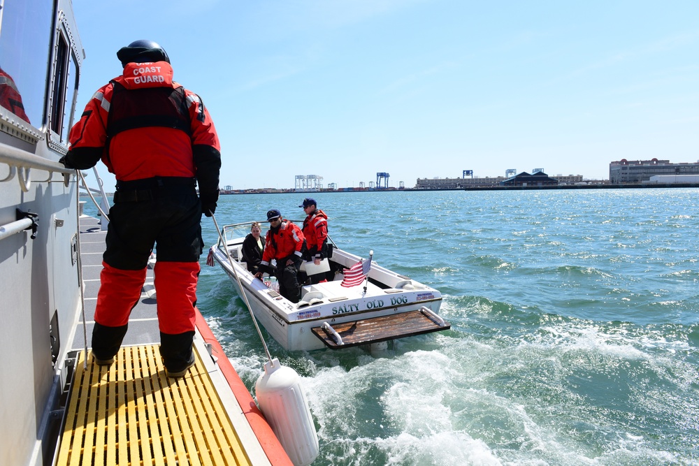 A Station Boston boat crew conducts a boarding in the Boston Harbor