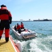 A Station Boston boat crew conducts a boarding in the Boston Harbor