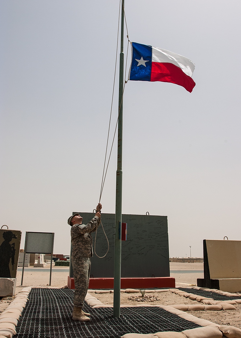 Texas flag raised as 36th CAB takes over operation at Camp Buehring, Kuwait.