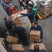 USS Shoup sailors unload pallets