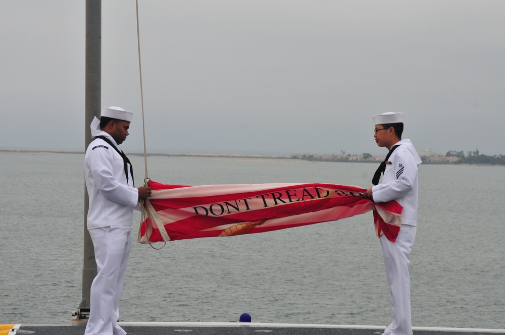 Sailors prepare flag
