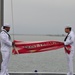 Sailors prepare flag